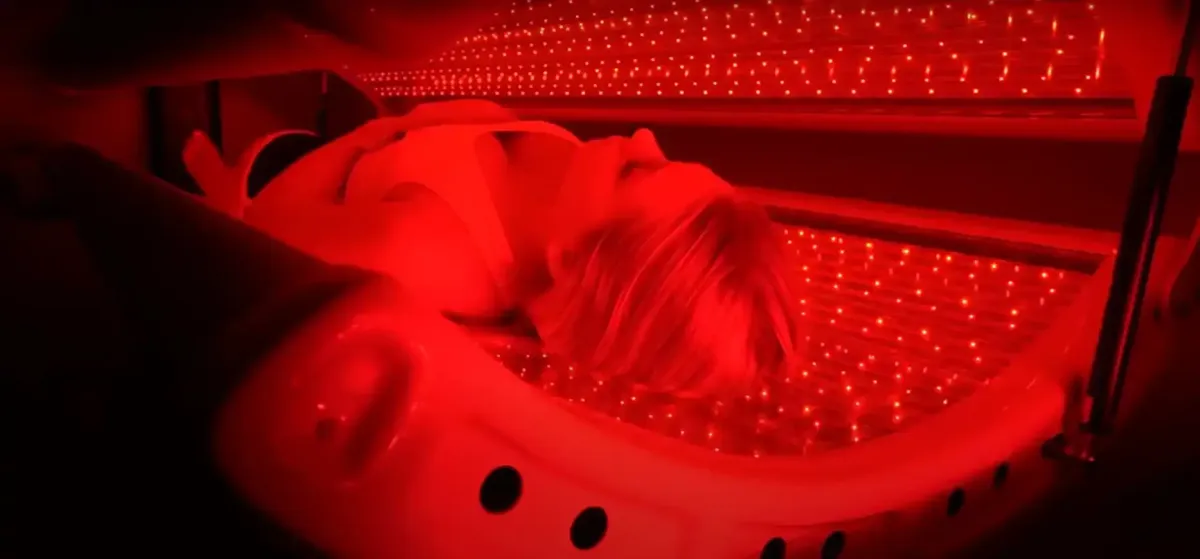 Woman in Red Light Therapy Bed