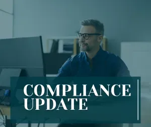 A professional man with glasses sitting at a desk and working on a computer. The image has a dark teal overlay with a large text box in the foreground that reads "COMPLIANCE UPDATE" in white serif font.