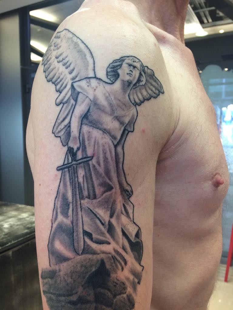 person in blue denim shorts and white nike sneakers standing on gray concrete floor