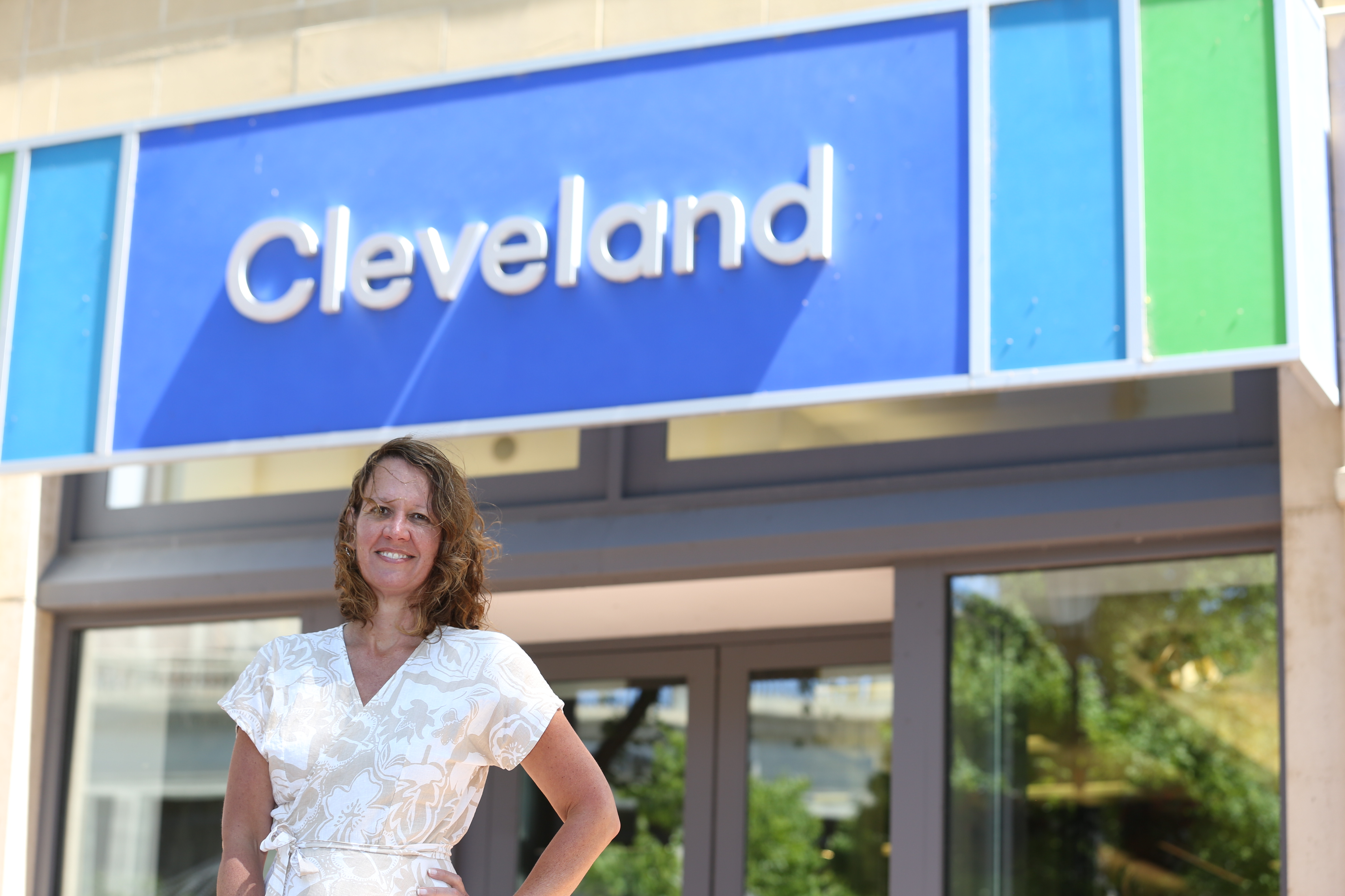 Laura outside, standing under a building sign that reads Cleveland
