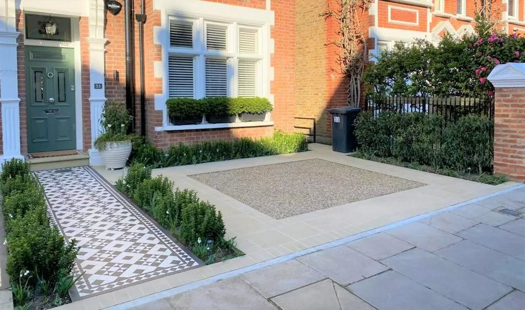 The driveway features an elegant design with interlocking pavers, providing a smooth and durable surface for vehicles. Lush greenery and colorful flowers border the driveway, enhancing its aesthetic appeal and blending harmoniously with the surrounding natural environment.