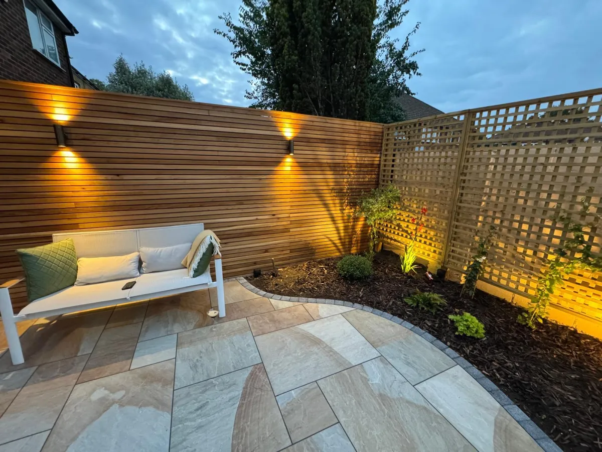 The patio is crafted from high-quality materials, creating a durable and stylish outdoor living space. Comfortable patio furniture is arranged on the smooth surface, inviting relaxation and social gatherings. Lush plants and vibrant flowers adorn the patio's edges, adding a touch of natural beauty and tranquility to the overall ambiance.