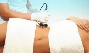 gold human face figurine on black table