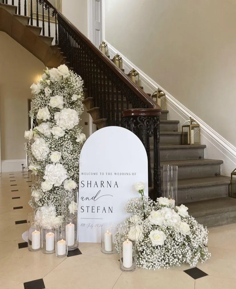 wedding welcome sign with floral arrangements