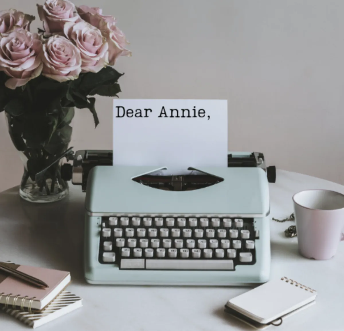 Image of green typewriter with words 'Don desk with pink roses with paper 'dear Annie'