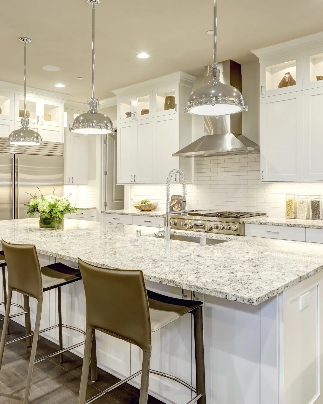 City buildings with mountains and cranes in background