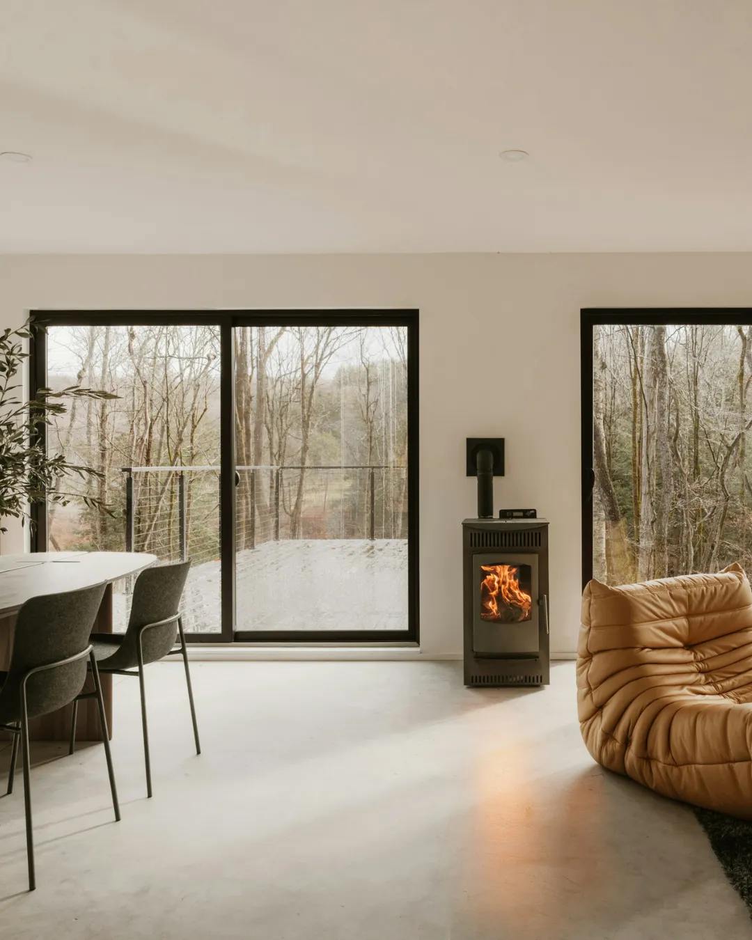 Industrial structures with scaffolding against a cloudy sky.