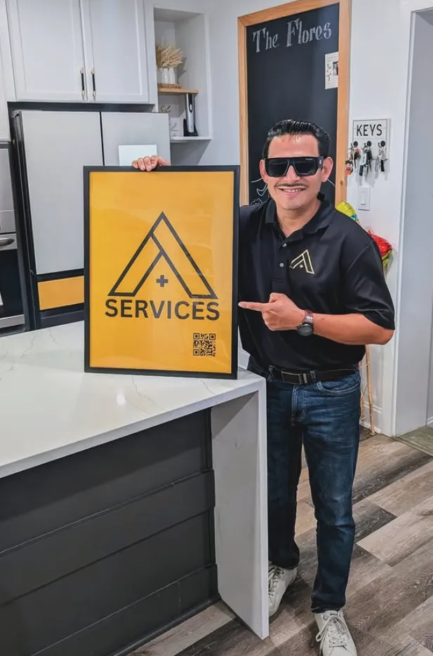 Veteran barber smiling with scissors in hand in a modern barbershop