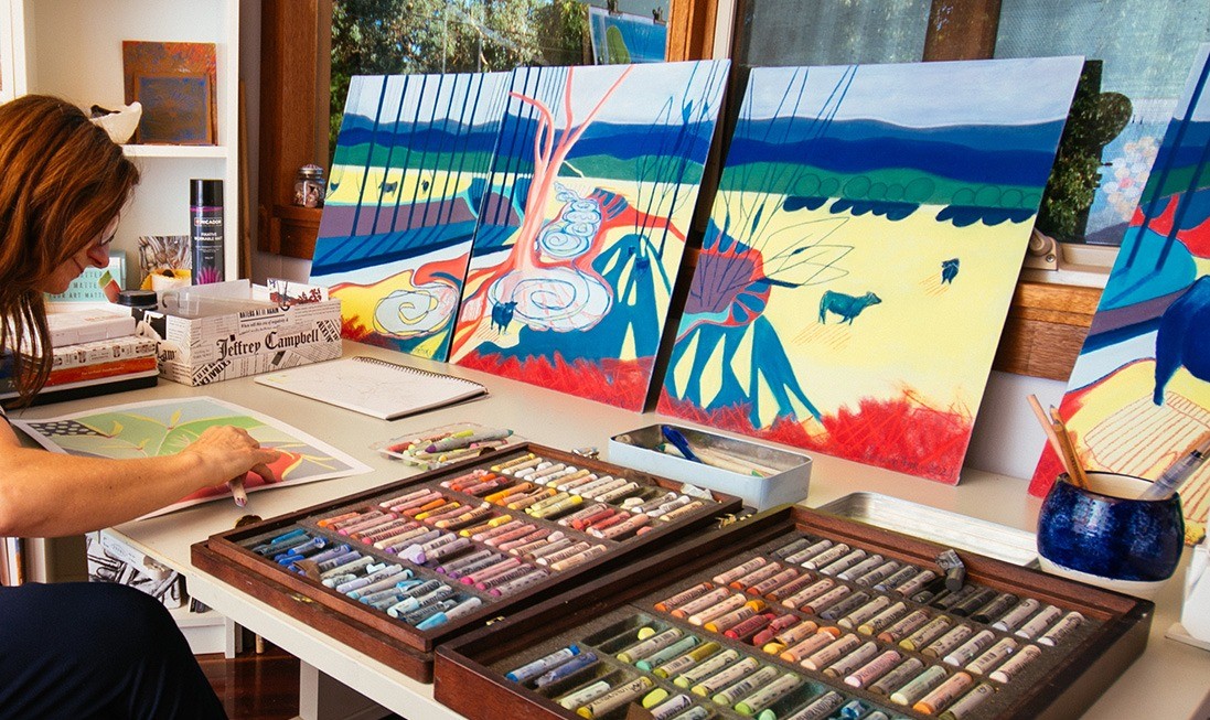 Sunlit minimalist art studio showing raw pigments, hand-stretched canvas, and artist tools on stone ivory surface