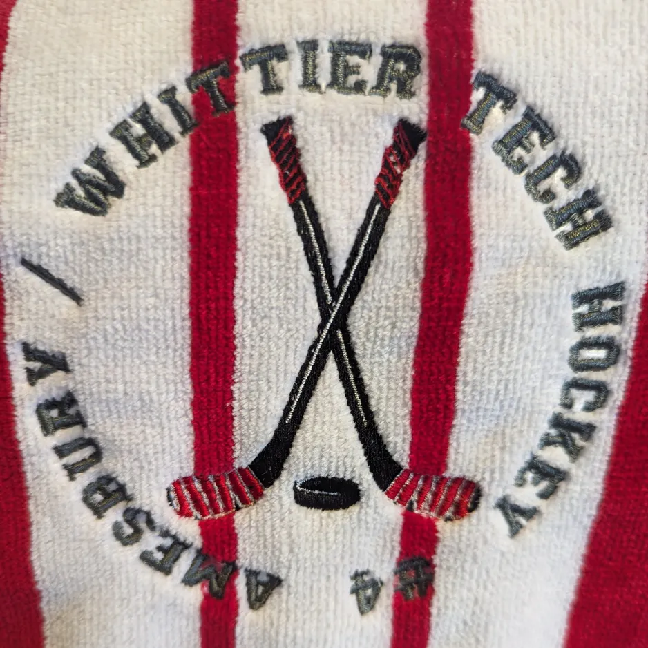 Embroidered hockey sticks and Winter Tech Hockey logo.