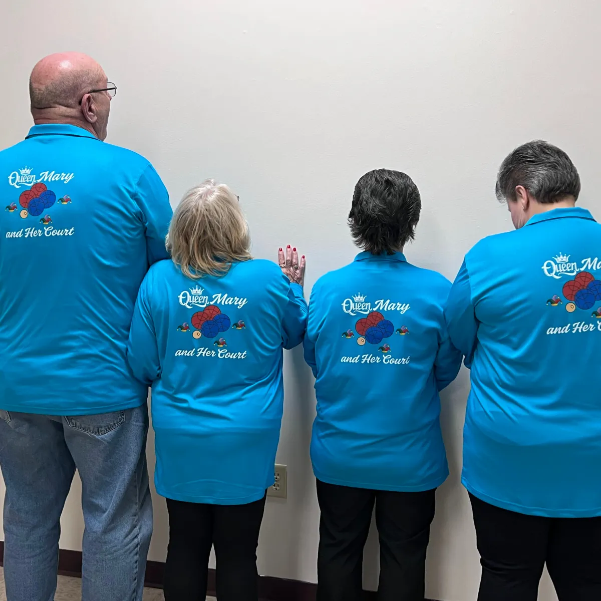 Group of four people wearing matching custom blue team t-shirts