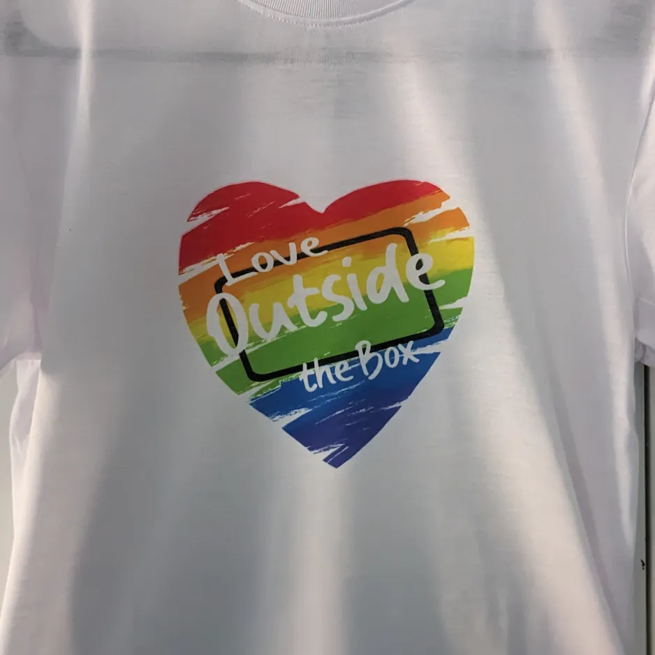 Custom designed fundraising t-shirts displayed alongside an online store interface on a tablet