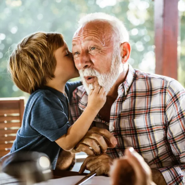 child whispering to grandpa
