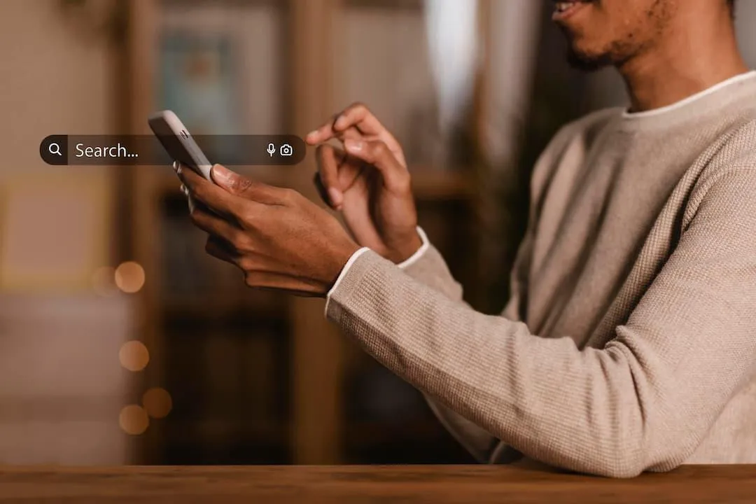 a man searching holding a phone to search on a search engine 