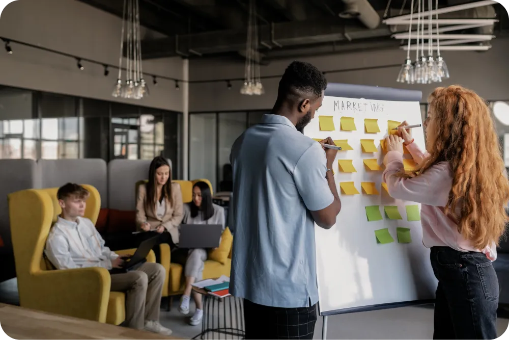 two event planner using a board and others are sitting 