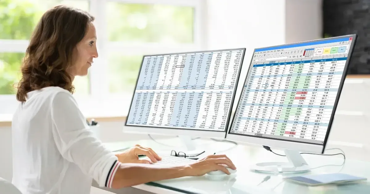 Professional medical billing specialist reviewing insurance claims at computer workstation