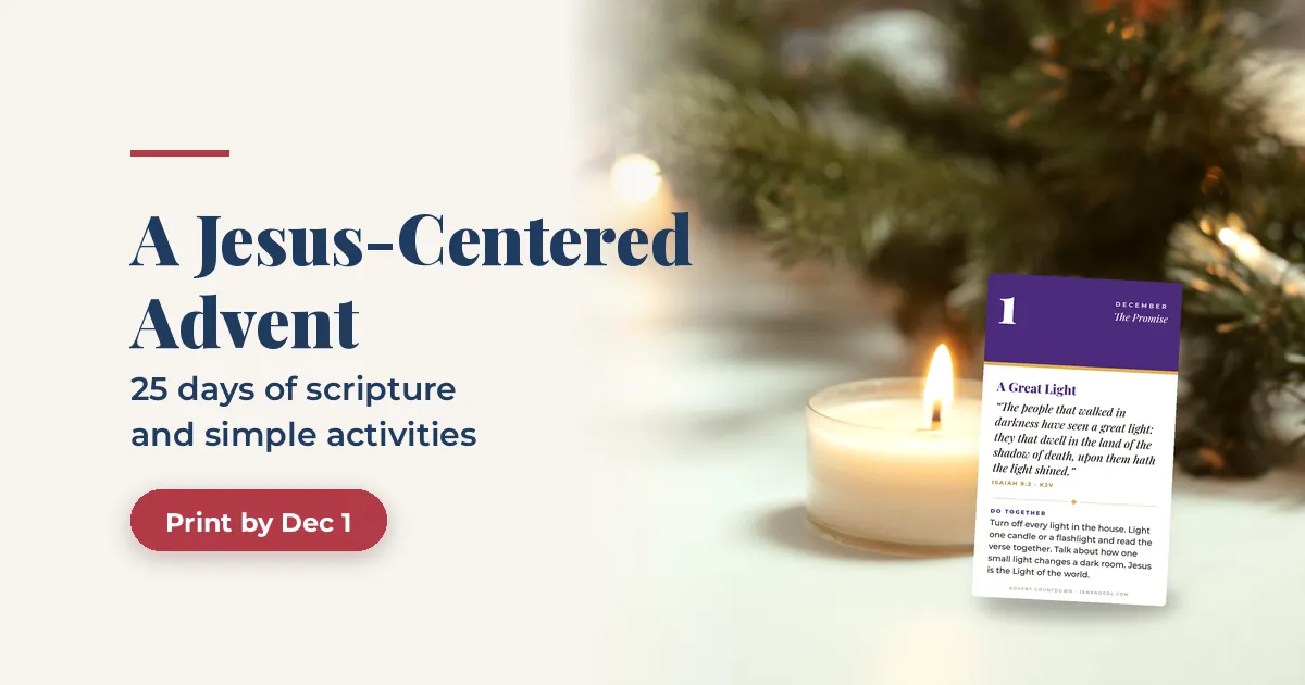 A Jesus-Centered Advent countdown card for December 1 propped beside a lit white candle and evergreen branches, with the headline A Jesus-Centered Advent, 25 days of scripture and simple activities