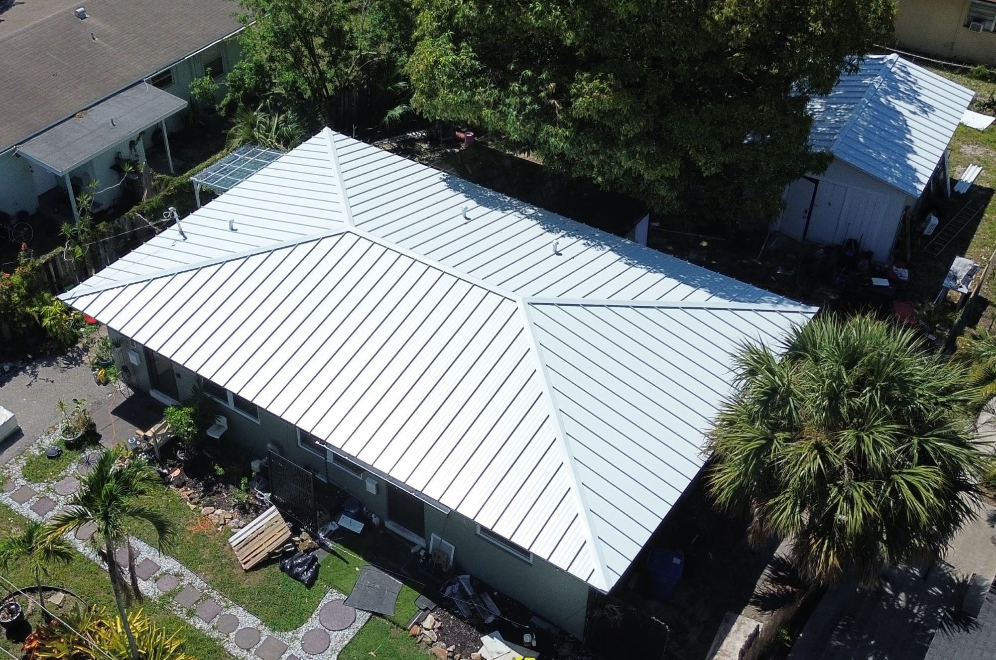 The roof of a building with a tree in the background