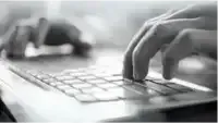 fingers typing at a keyboard