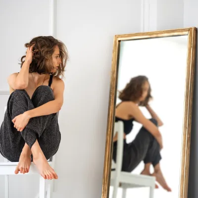 a young woman reflecting in the mirror about her identity