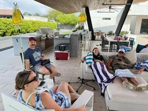 People relaxing outdoors with IV drips.