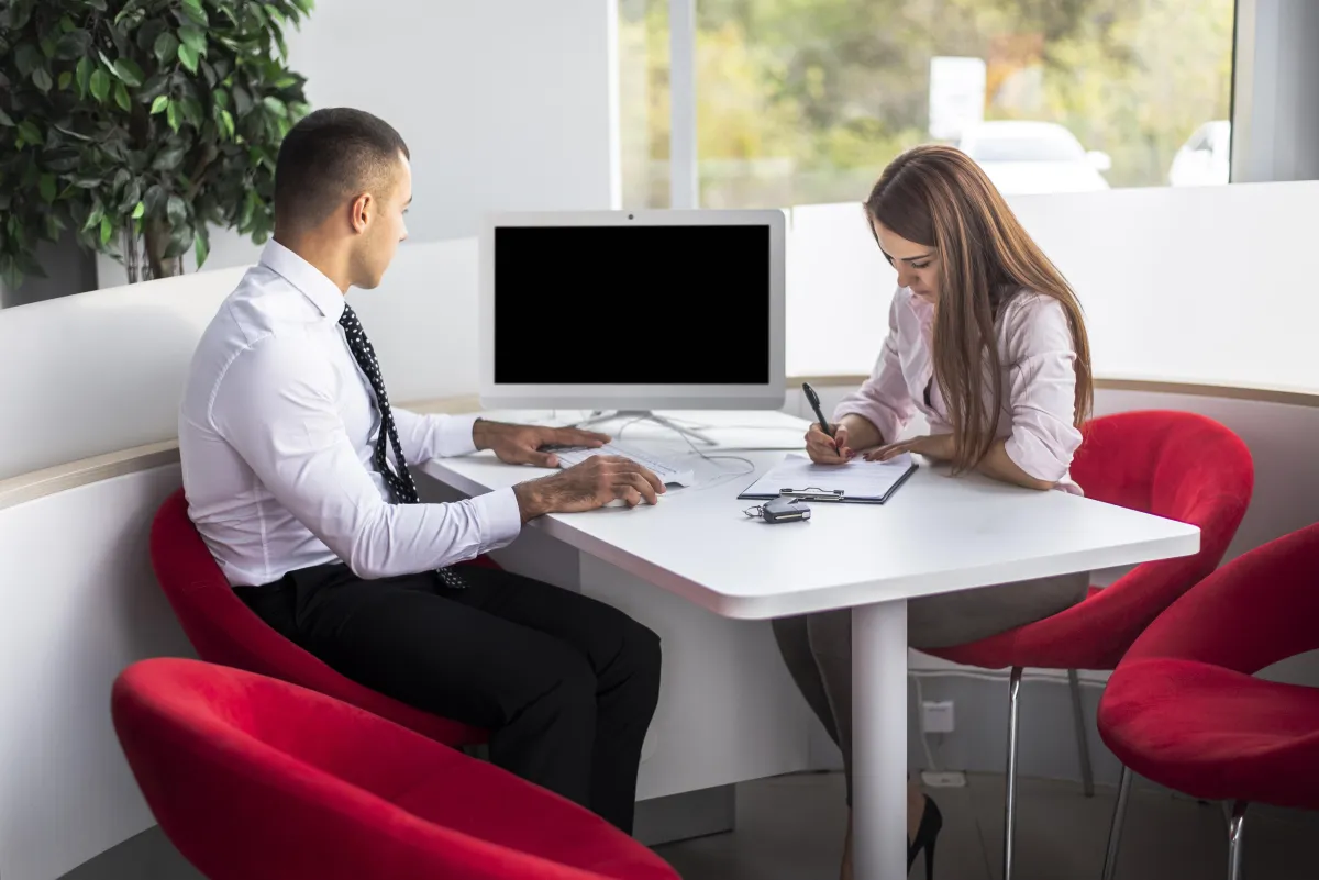Doctor and patient discussing at desk.
