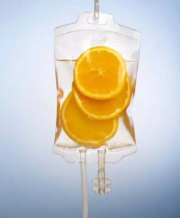 IV drip bag with orange slices symbolizing vitamin C infusion therapy