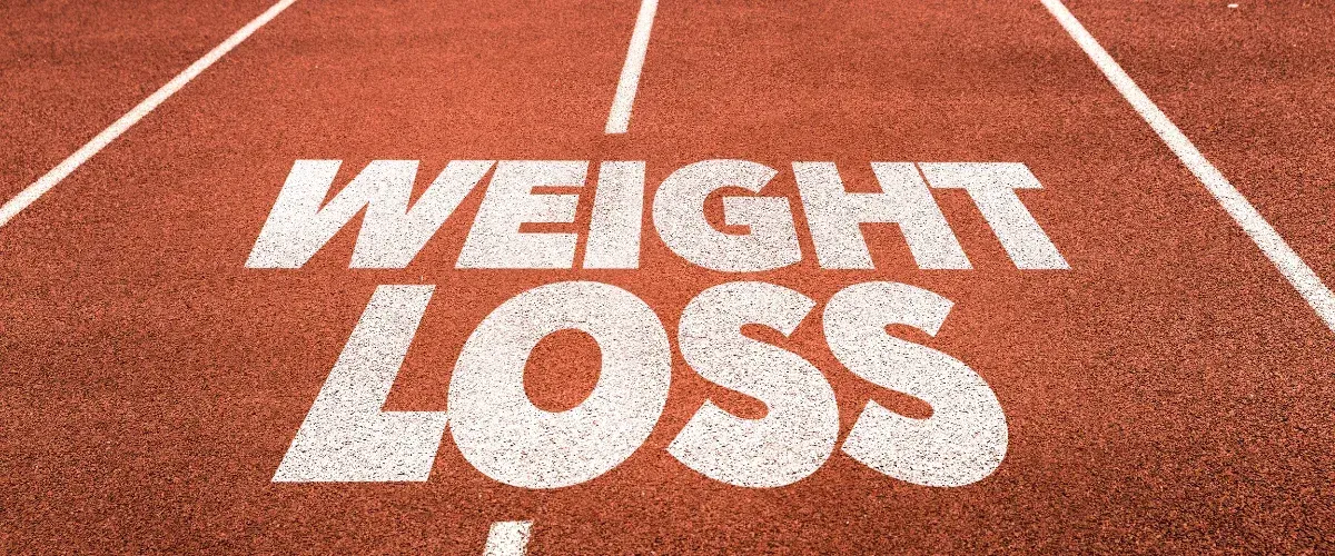 Track with the words weight loss symbolizing fitness and motivation journey