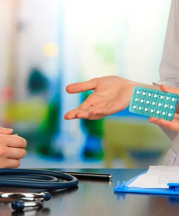 Doctor presenting hormonal birth control pills during patient consultation”