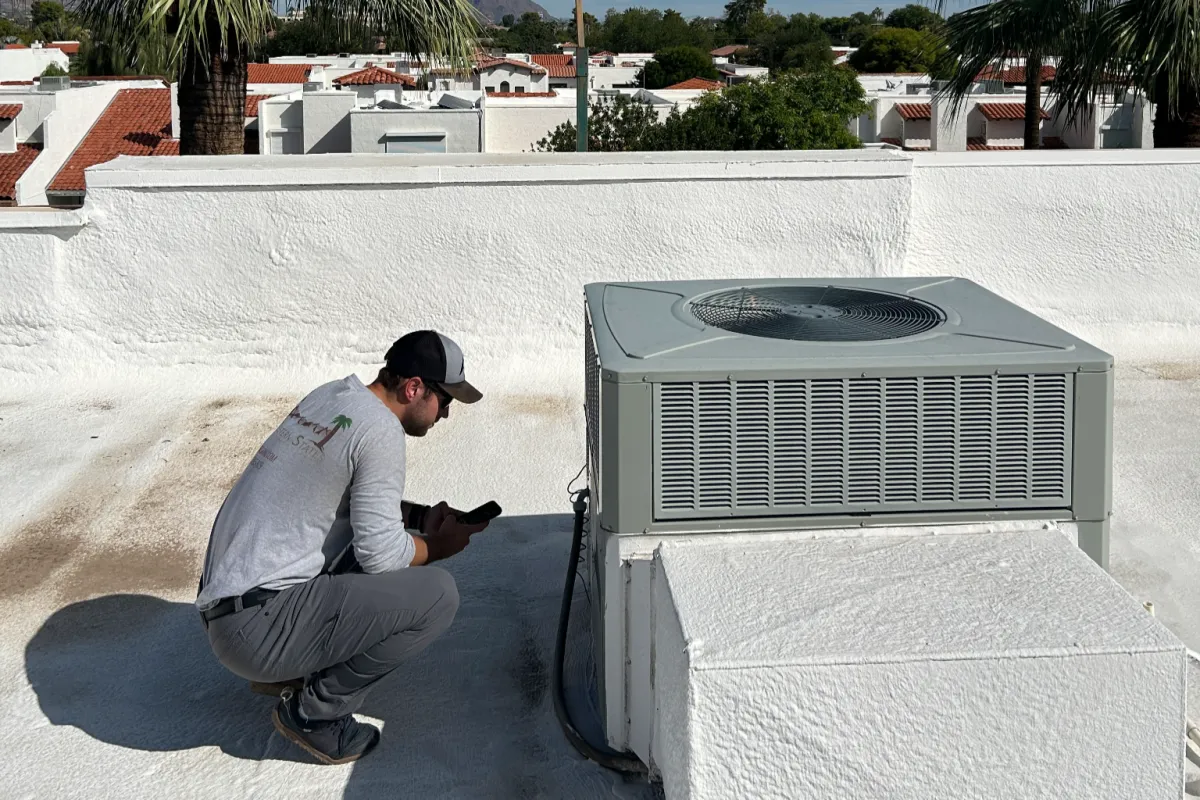 Big 6 structural and systems home inspection in Queen Creek Arizona showing inspector evaluating rooftop HVAC unit and major components