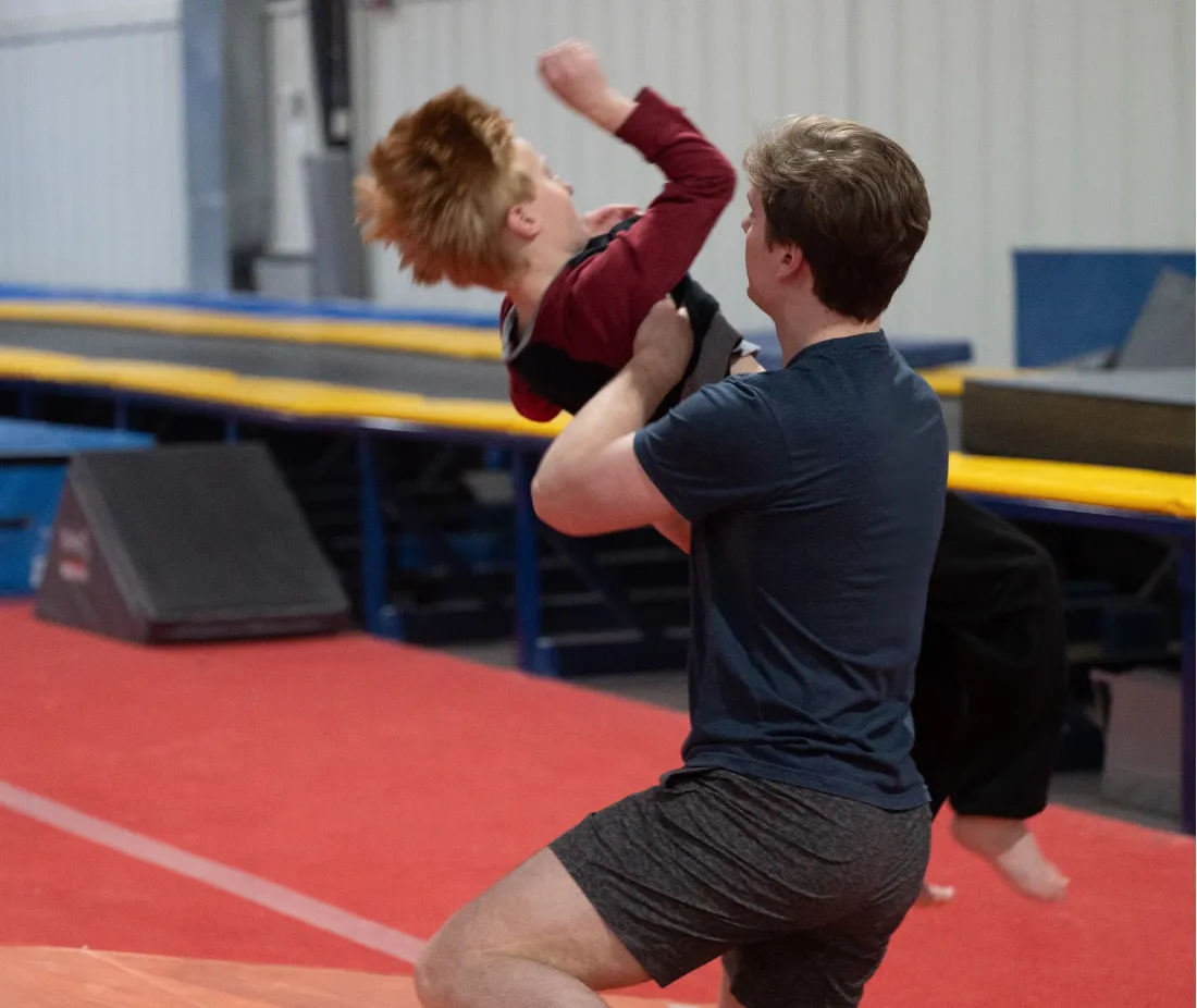 Coach spotting a young gymnast 