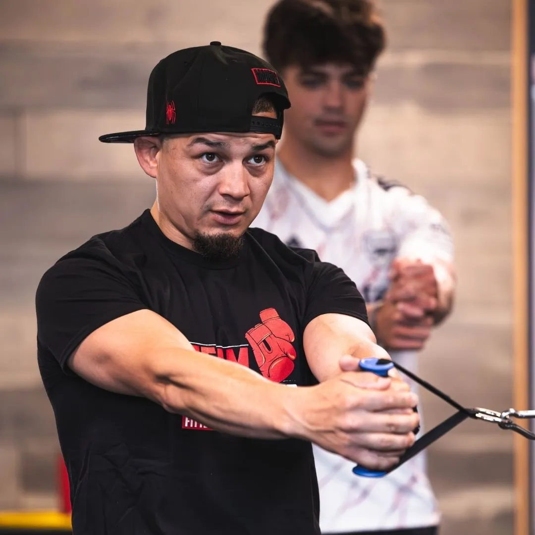 Trainer demonstrating moves to teenage client