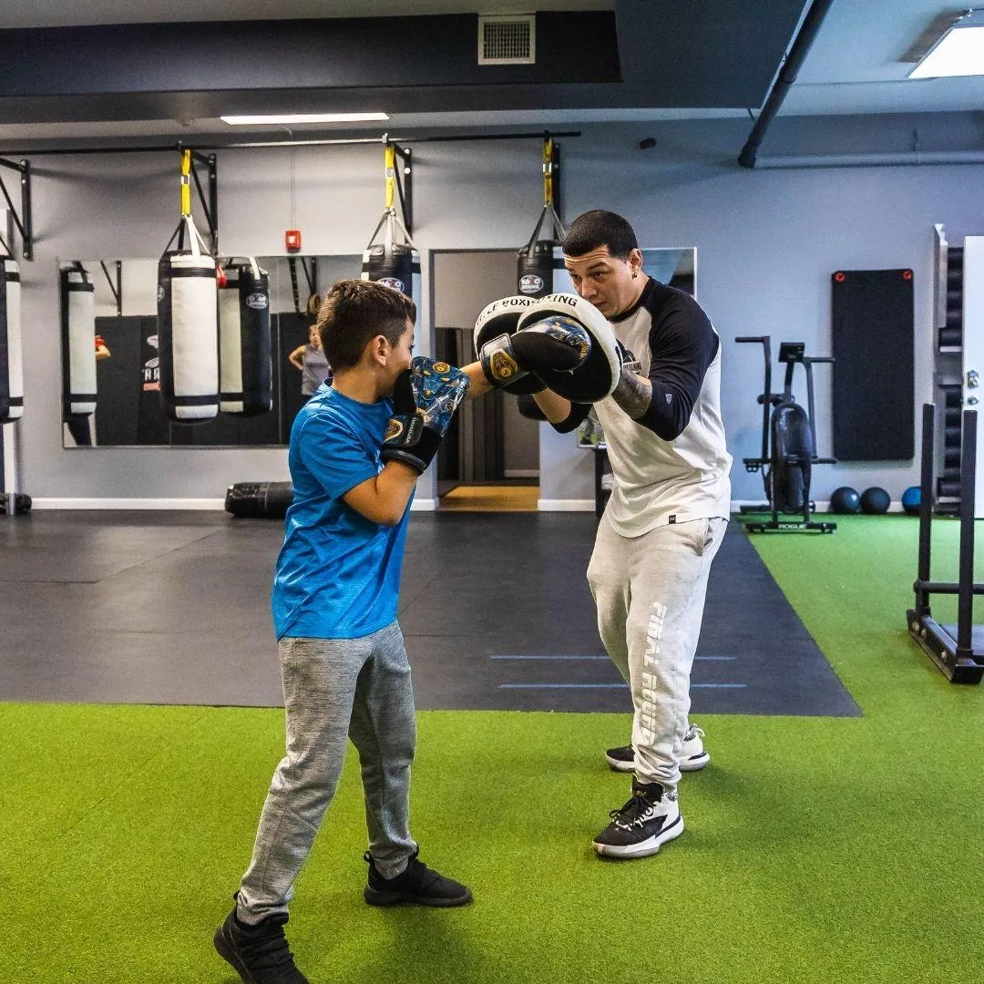 Young Client Boxing on the Pads