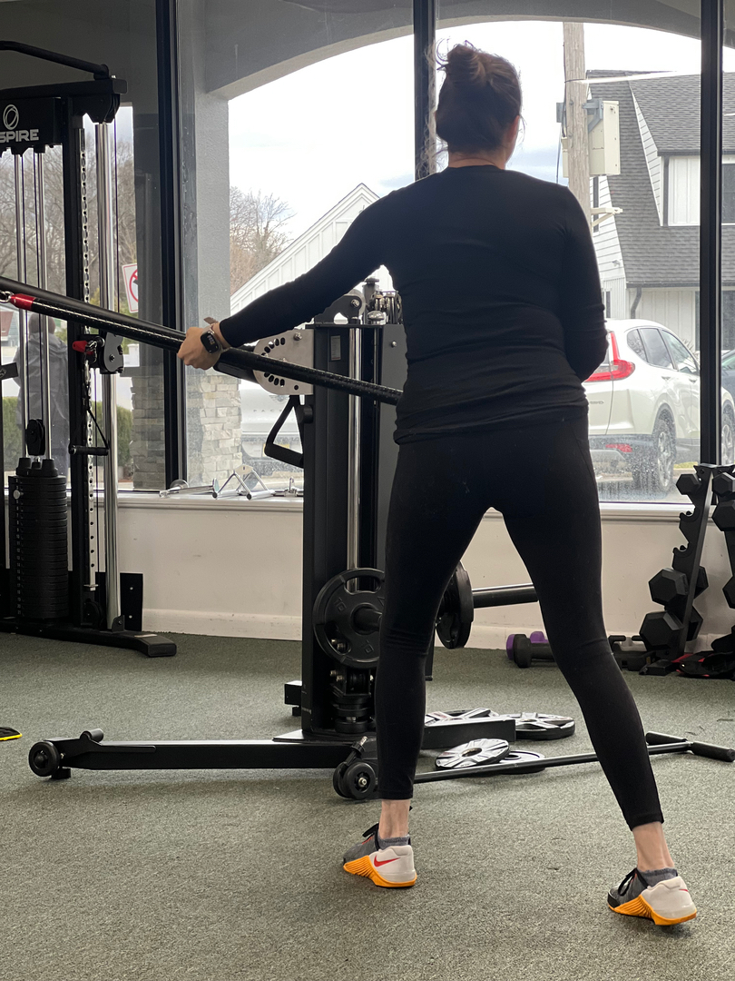 Woman performing a landmine core exercise at Esteem Biomechanics personal training studio in Waldwick, NJ near Allendale