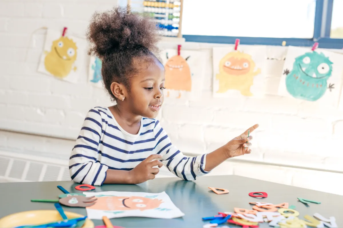 Girl follows directions during arts and crafts time.