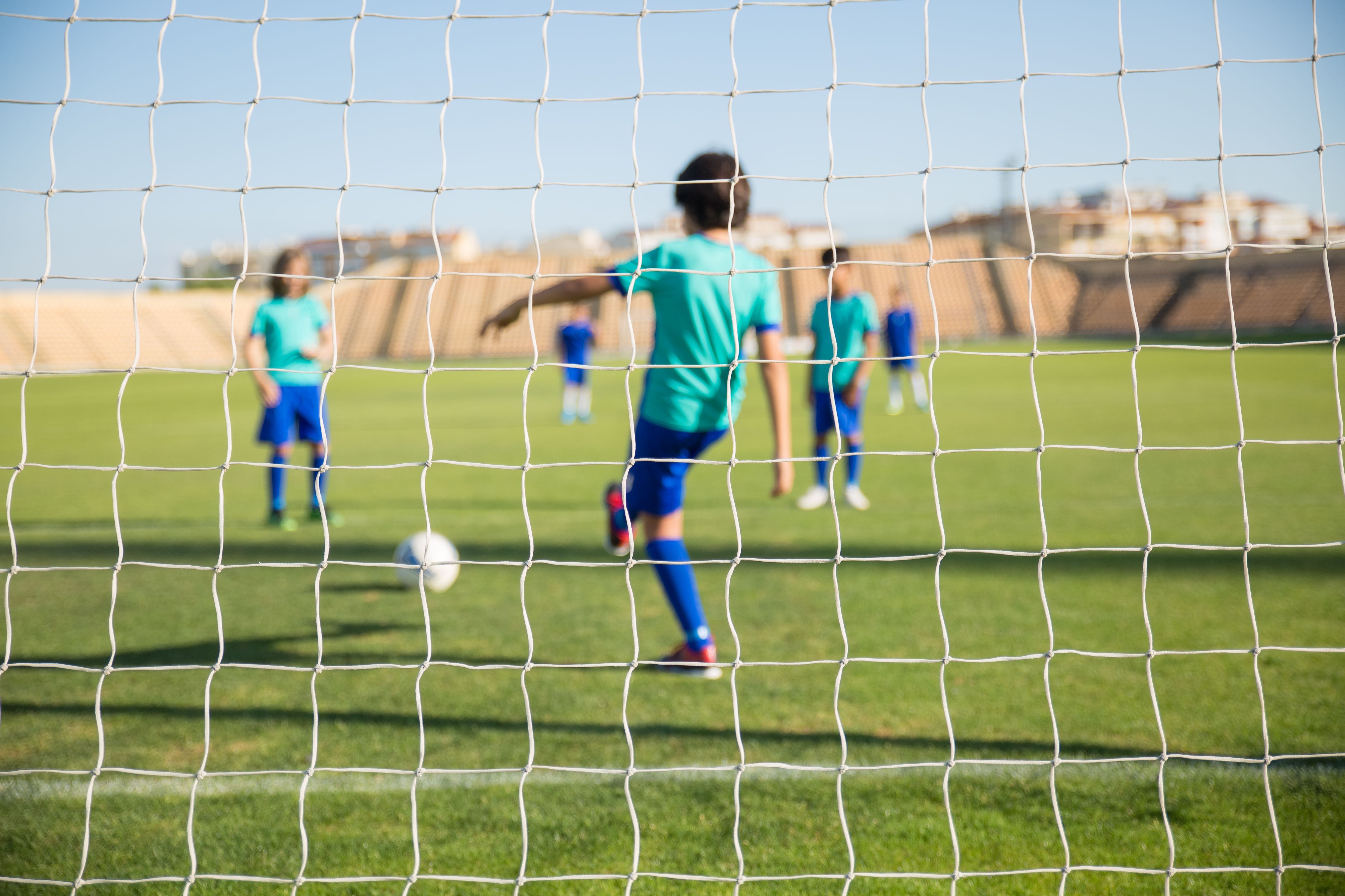 3 kids playing soccer