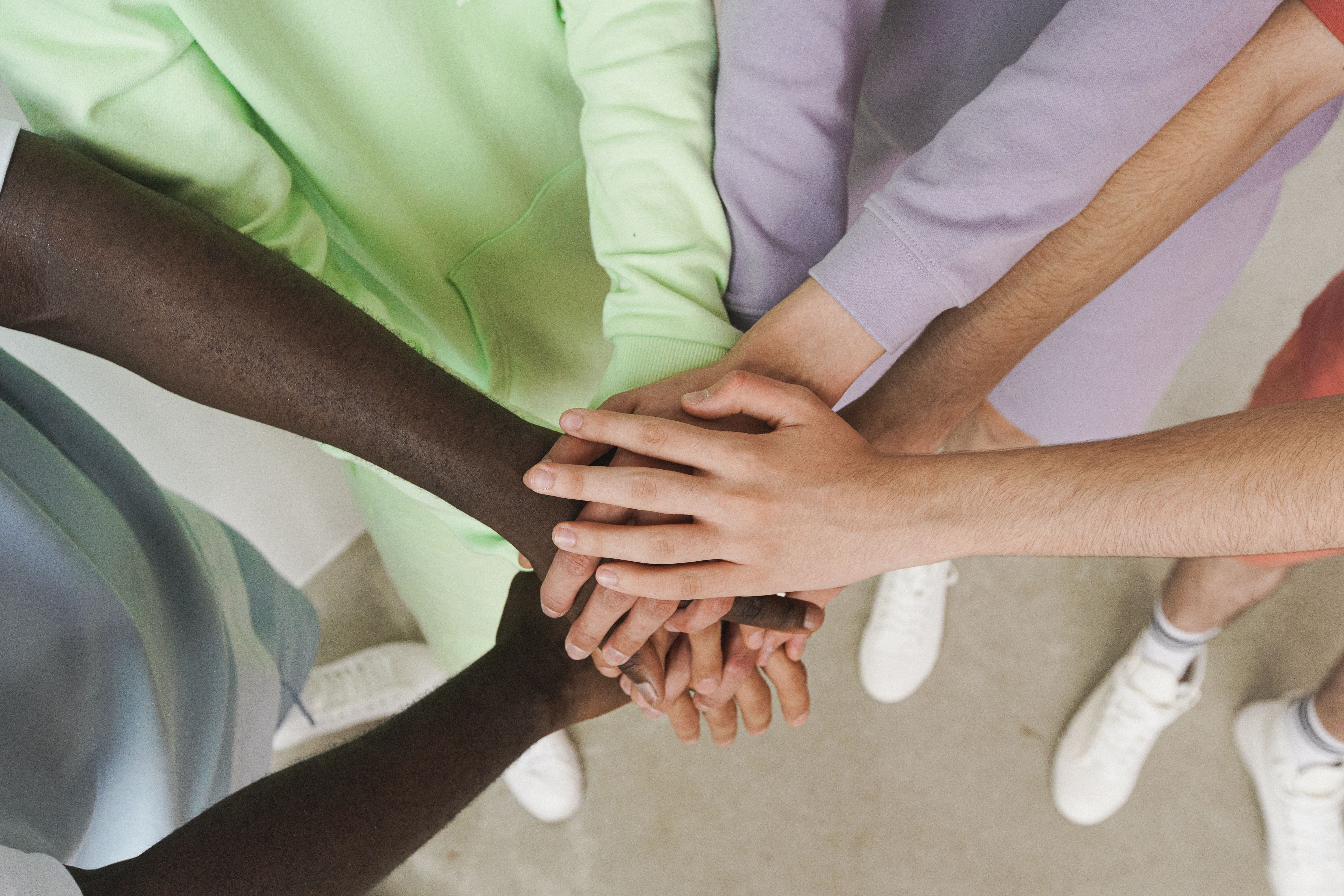 group of people putting hands together