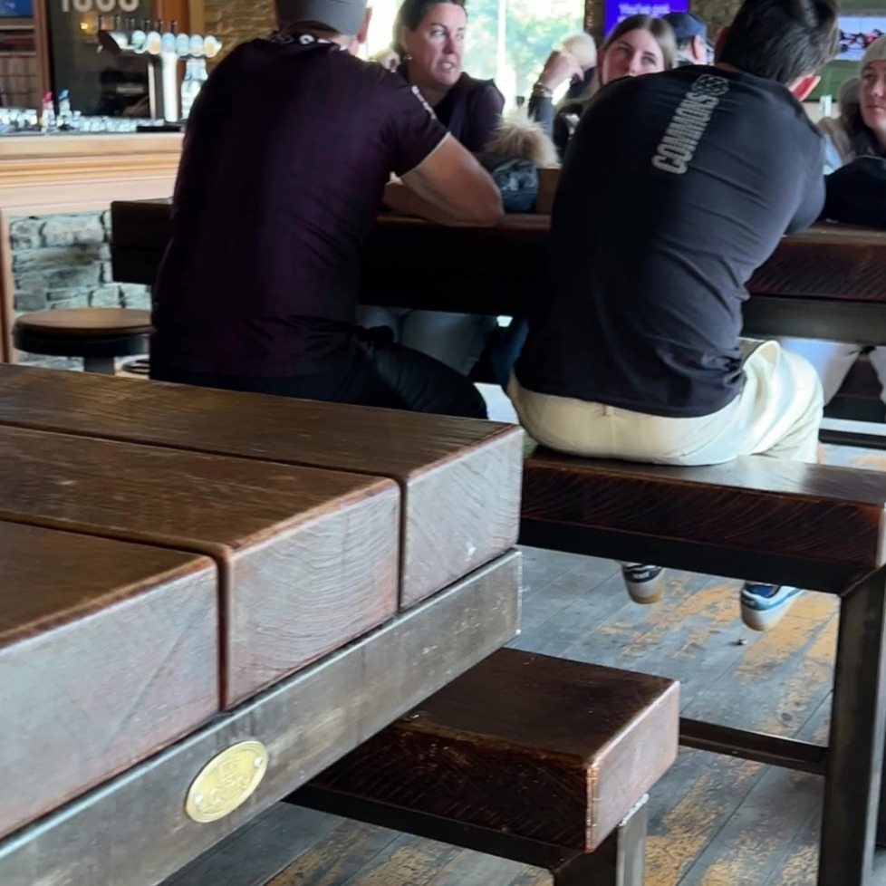 tables outside a restaurant with people enjoying ther evening sitting at the tables