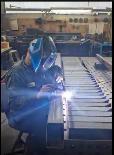 Artisan hands working with precision hand tools on raw timber inside the workshop