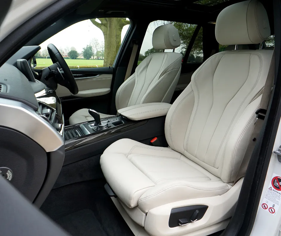Professionally detailed vehicle interior with clean leather seats, refreshed surfaces, and restored cabin appearance