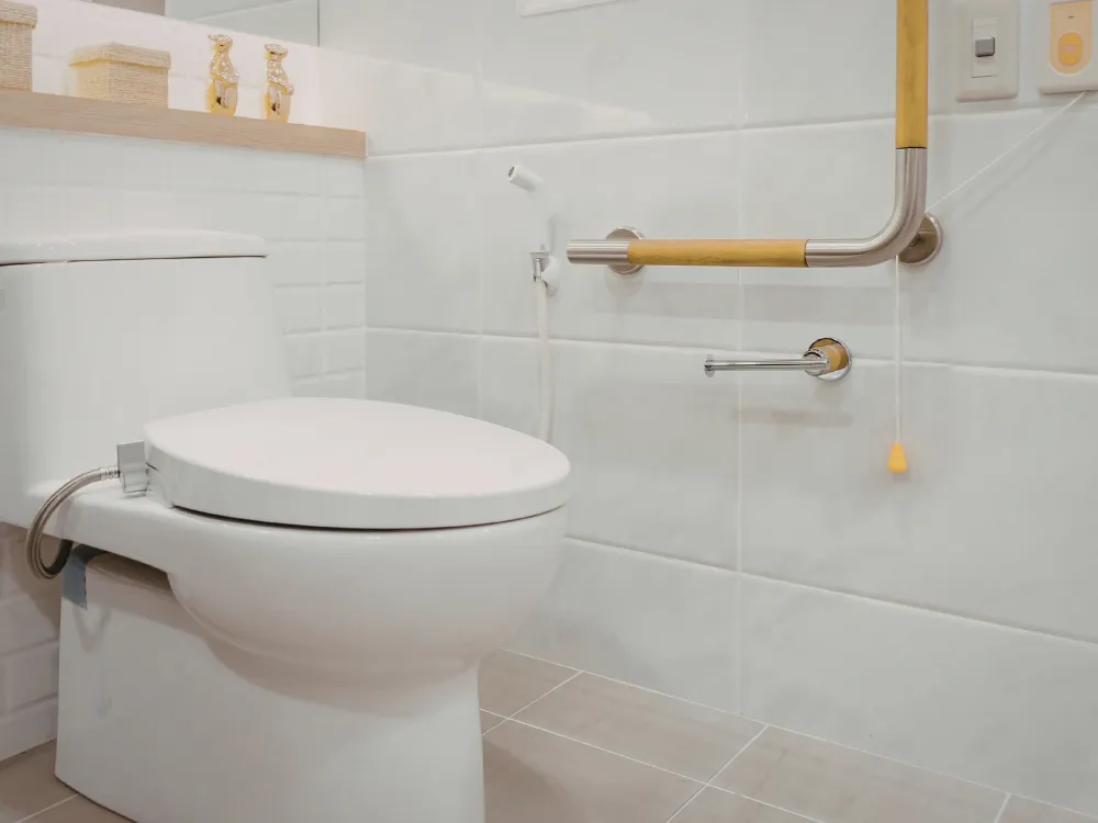 A fully accessible bathroom featuring a walk-in shower, safety grab bars, a raised toilet, and slip-resistant flooring, illustrating the type of custom accessibility remodels TCP Building Corp designs to improve comfort, safety, and independence in homes and businesses.