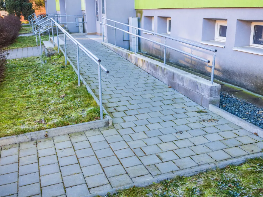 Wheelchair positioned on an outdoor accessibility ramp in winter.