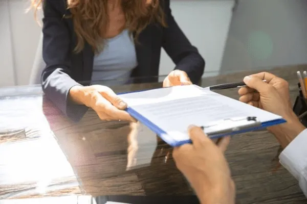 Woman shares paperwork on clipboard