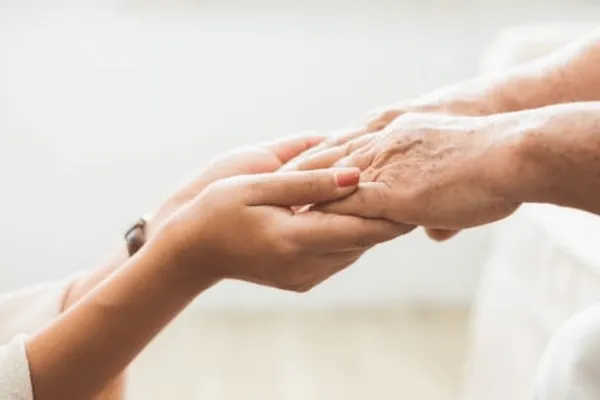 grasping hands in a caring way