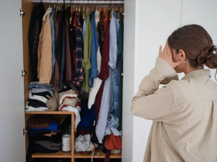 stressed woman looking at closet