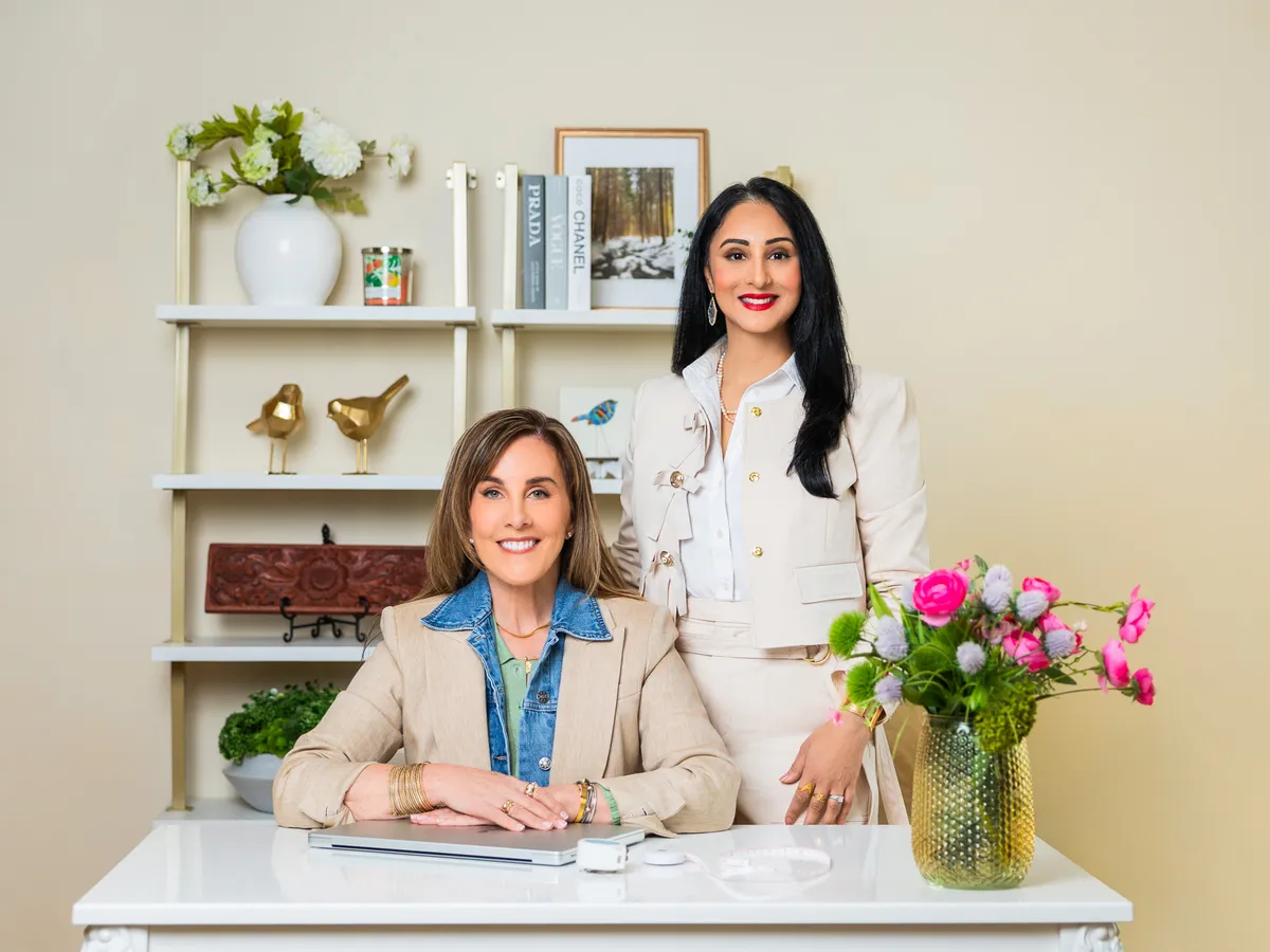 Lisa Malone and Batul Sadiq, business partners behind You Have Arrived!, pictured together in their workspace.