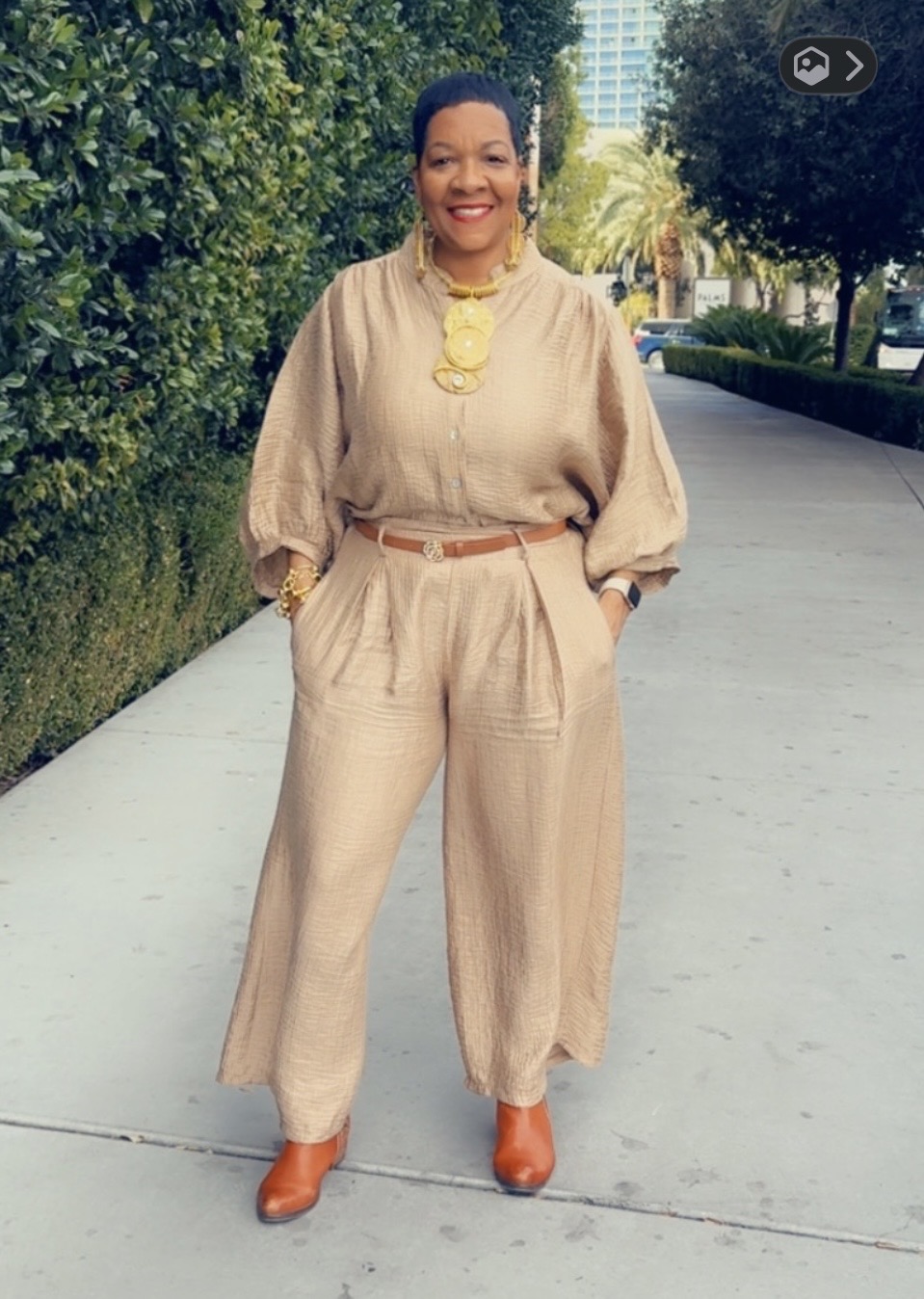 Phyllis Brown Brewer in tan outfit full-body shot, exuding elegant confident style