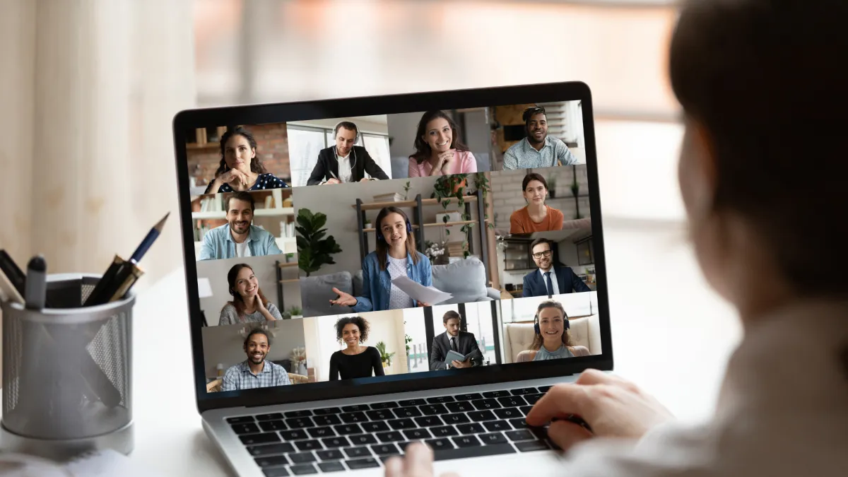 a person sitting at a table with a laptop