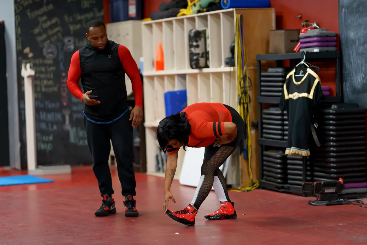 A man and a woman boxing in a gym