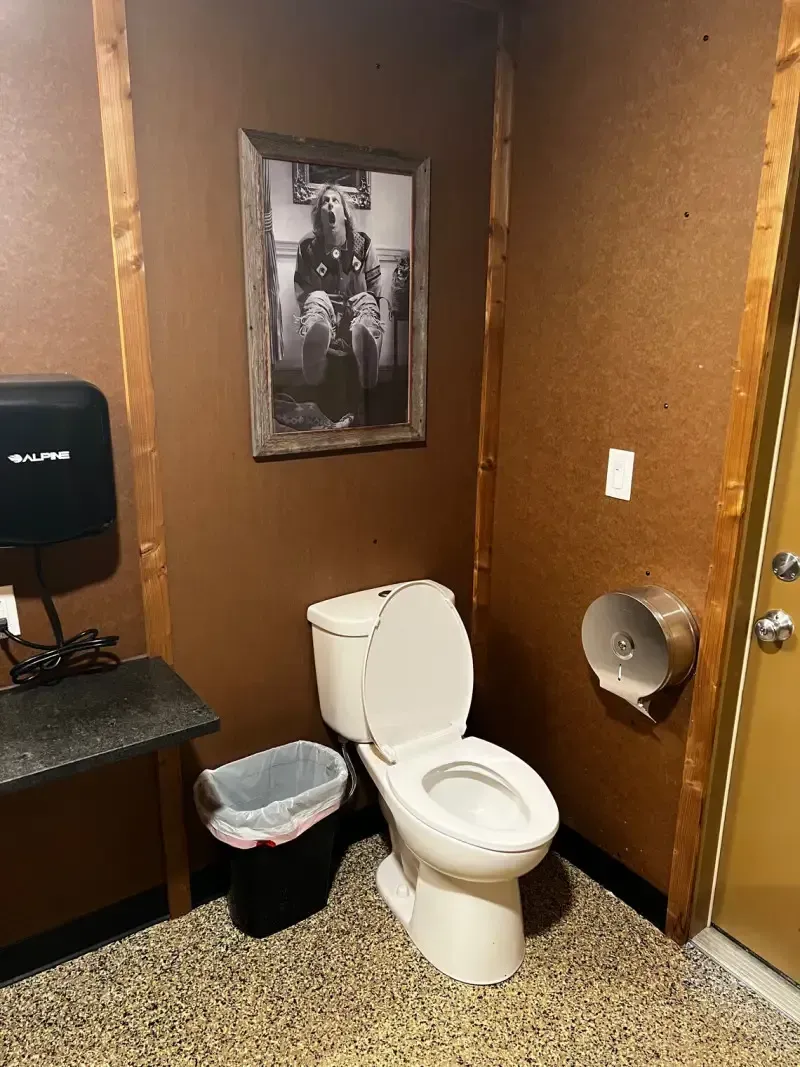 Private campground restroom at SOBO's Campground with modern toilet, spacious layout, rustic finishes, and clean amenities for guests.